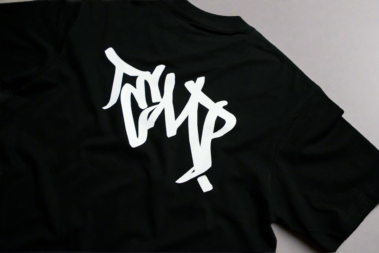 Black t-shirt with white graphic design on a gray background