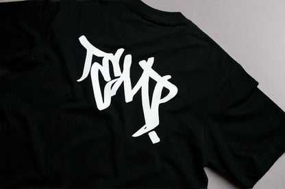 Black t-shirt with white graphic design on a gray background