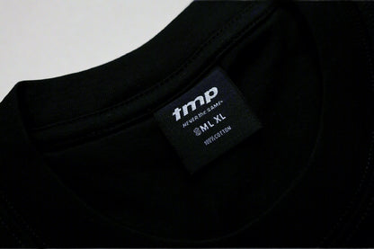 Black t-shirt with a brand label on a light gray background