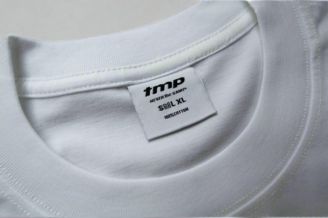 White t-shirt with a brand label on a grey background