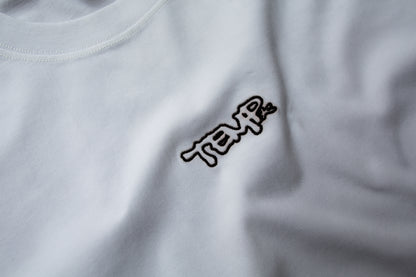 Close-up of a white shirt with a black logo on a plain background